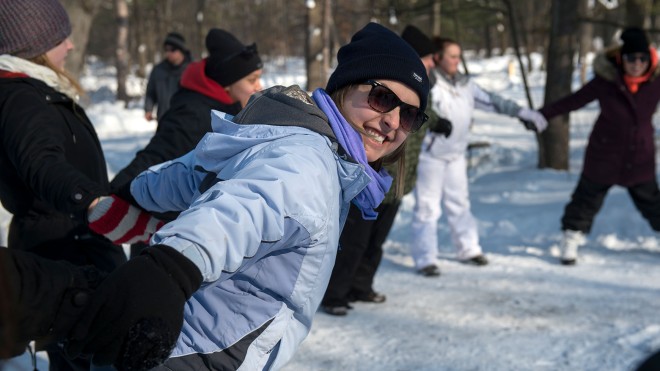Recreation student on an outdoor trip holding hands with a group circle