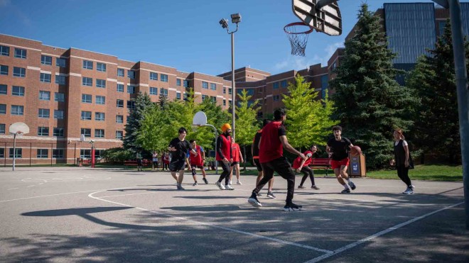 Students playing drop in basketball