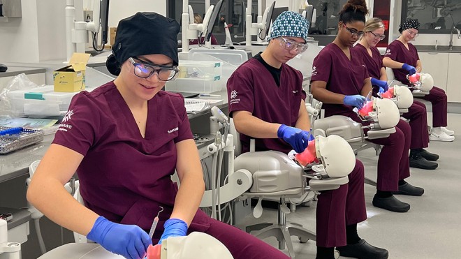 Photo of dental hygiene students working in the lab