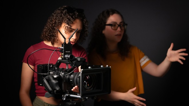 Film students look at a shot through a camera