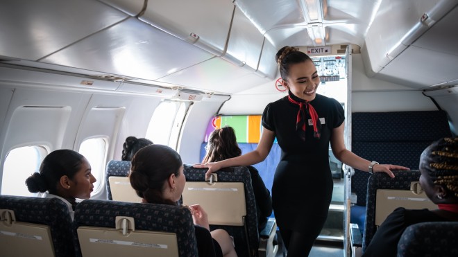 Flight Services student talking to airplane passsengers