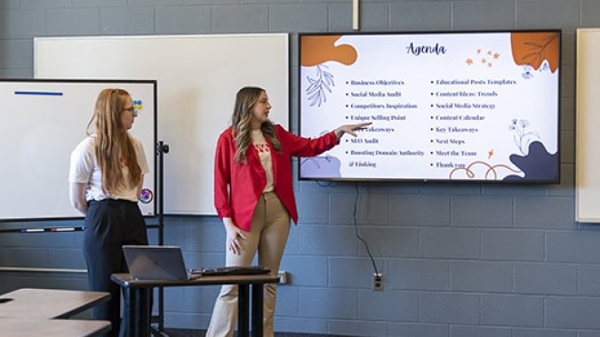two students present marketing slides