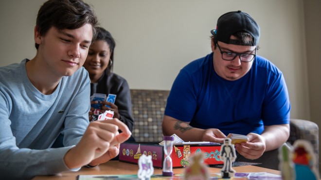 students in residence playing a board game together