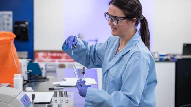 Biotechnology student working in a science lab environment.