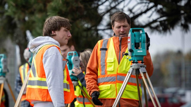 Faculty member and student using an optical levelling kit