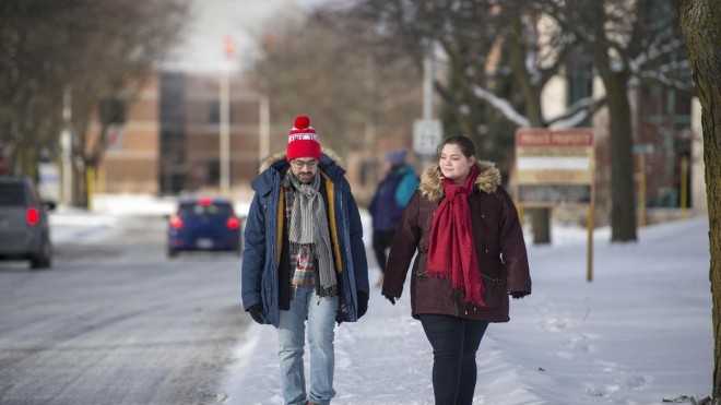two students walk together at fanshawe in winter