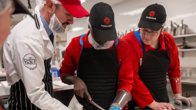 Students learning butchery techniques