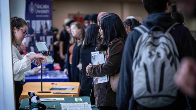 A Fanshawe student interacting with a booth at the pathways fair