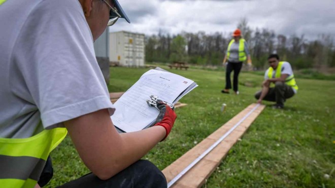students work with lumber at a trades workshop at COTTFN