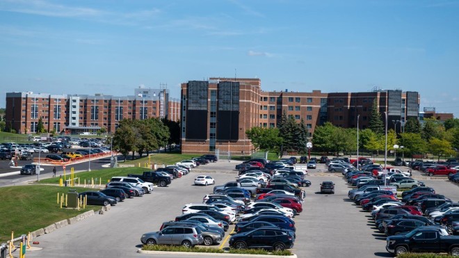 parking lot outside student wellness centre filled with parked vehicles