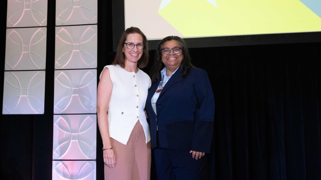Tracie Skolny, left, receives the Teacher of the Year Award from the American Massage Therapy Association