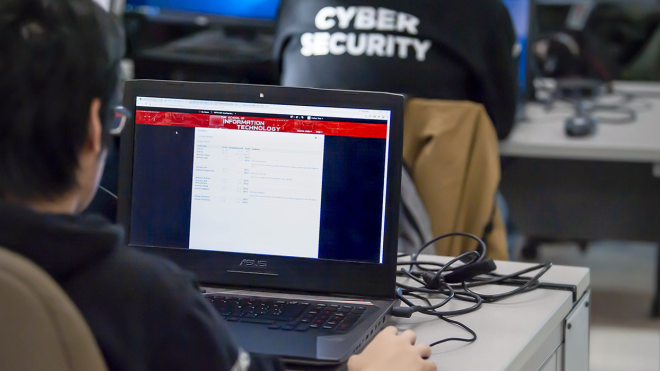 Backs of heads of students in a computer lab scrolling on web pages