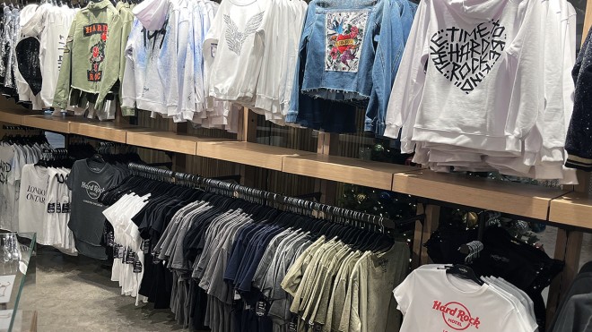 Rows of clothing hanging on a display in the Hard Rock Hotel Rock Shop