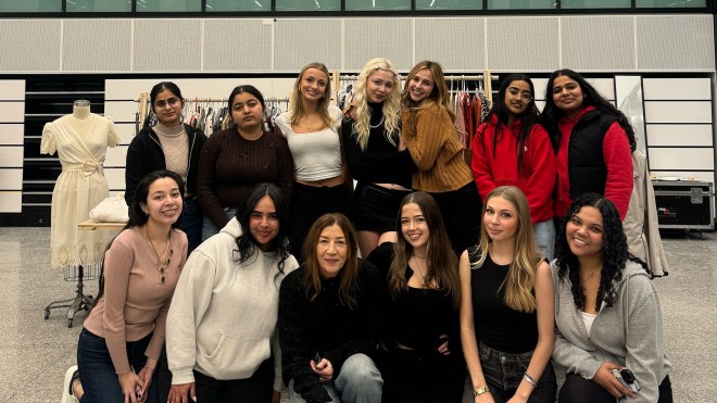 A group of smiling students poses for the camera.