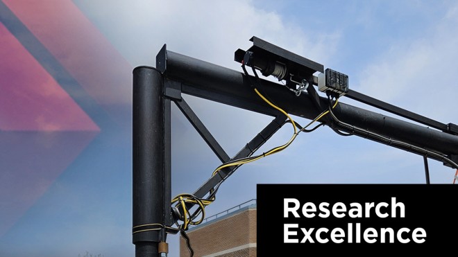 Closeup of a small crane with white text saying Research Excellence