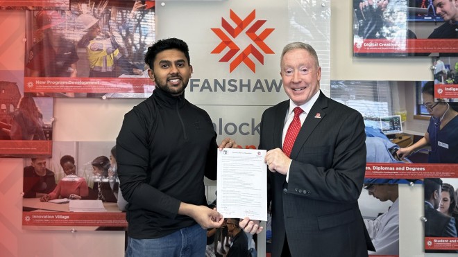 Photo of two men in formal clothing holding a document