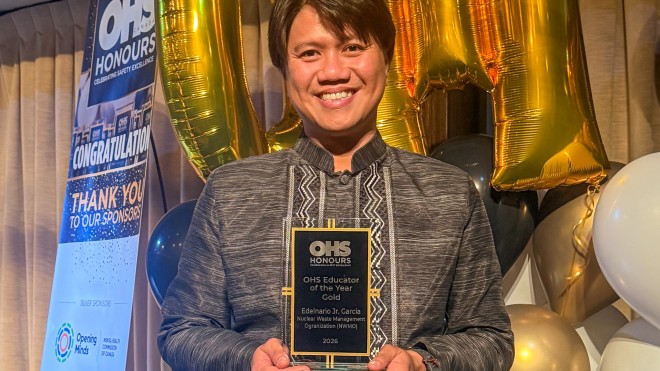 Individual holding a 2026 OHS Educator of the Year Gold award at the OHS Honours ceremony.