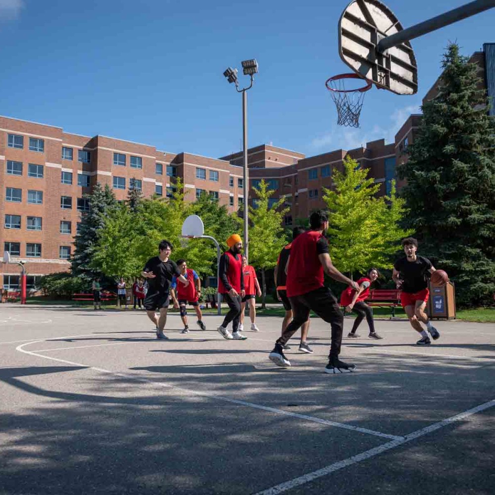 Students playing drop in basketball