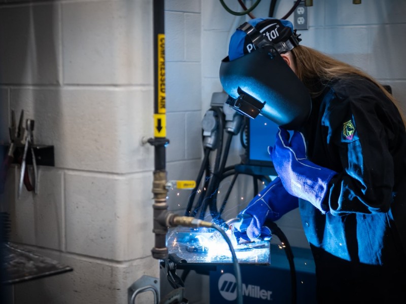 woman wearing a welding hood while welding