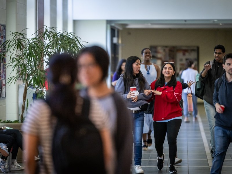 students walk down hallway at Fanshawe