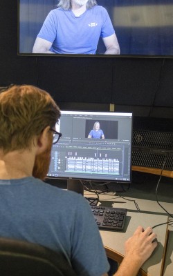 Broadcasting - Television and Film Production student editing video in studio
