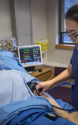 Nursing student checking mannequin