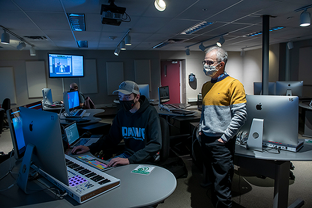 Audio Post Production faculty member reviews students work