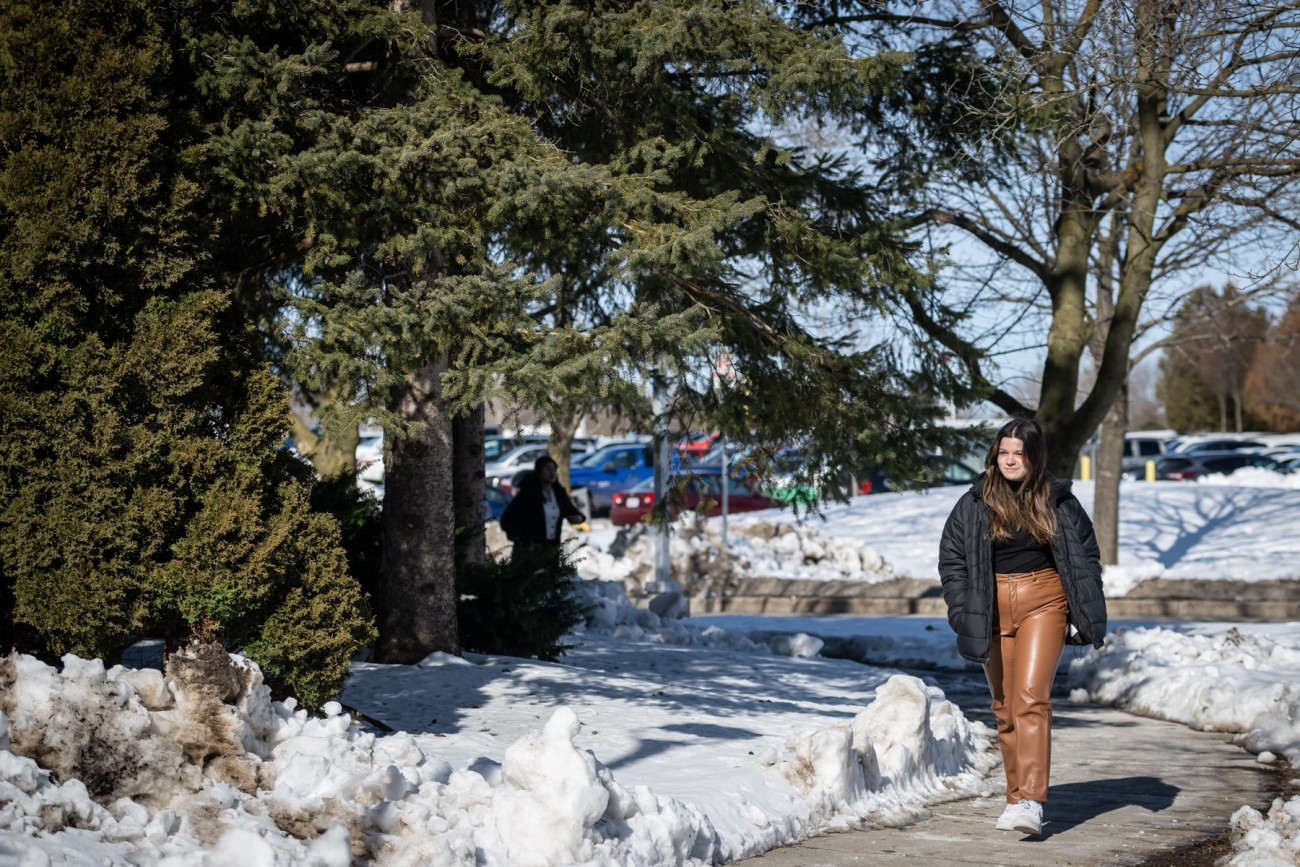 student walking on fanshawe campus in winter