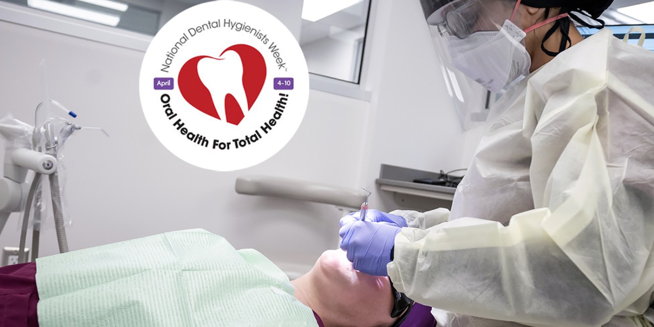 A dental hygiene student wearing a face mask, gloves, and scrubs is using a dental tool to examine a patient lying on a medical bed. A superimposed logo shows a tooth inside a red circle surrounded by the words National Dental Hygienists Week..