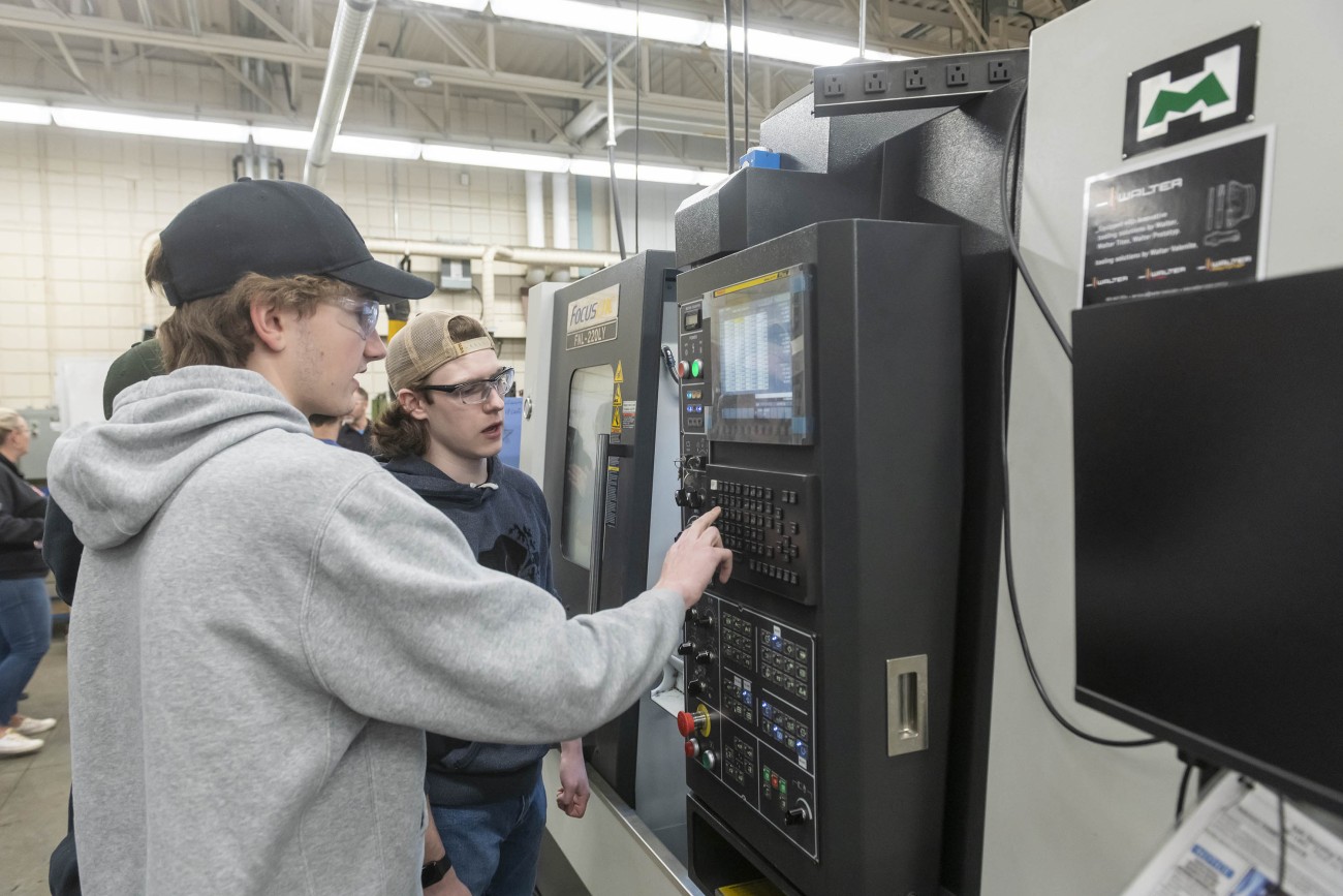 students working with a CNC machine