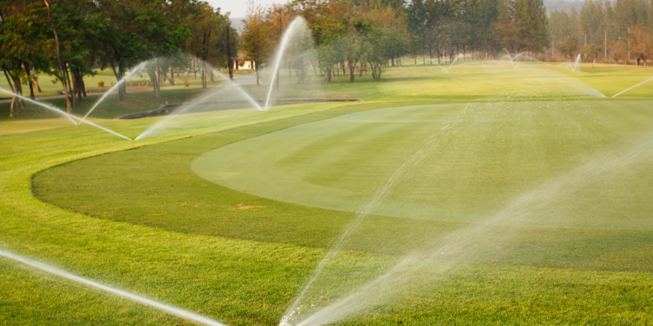 a golf course being watered by an irrigation system
