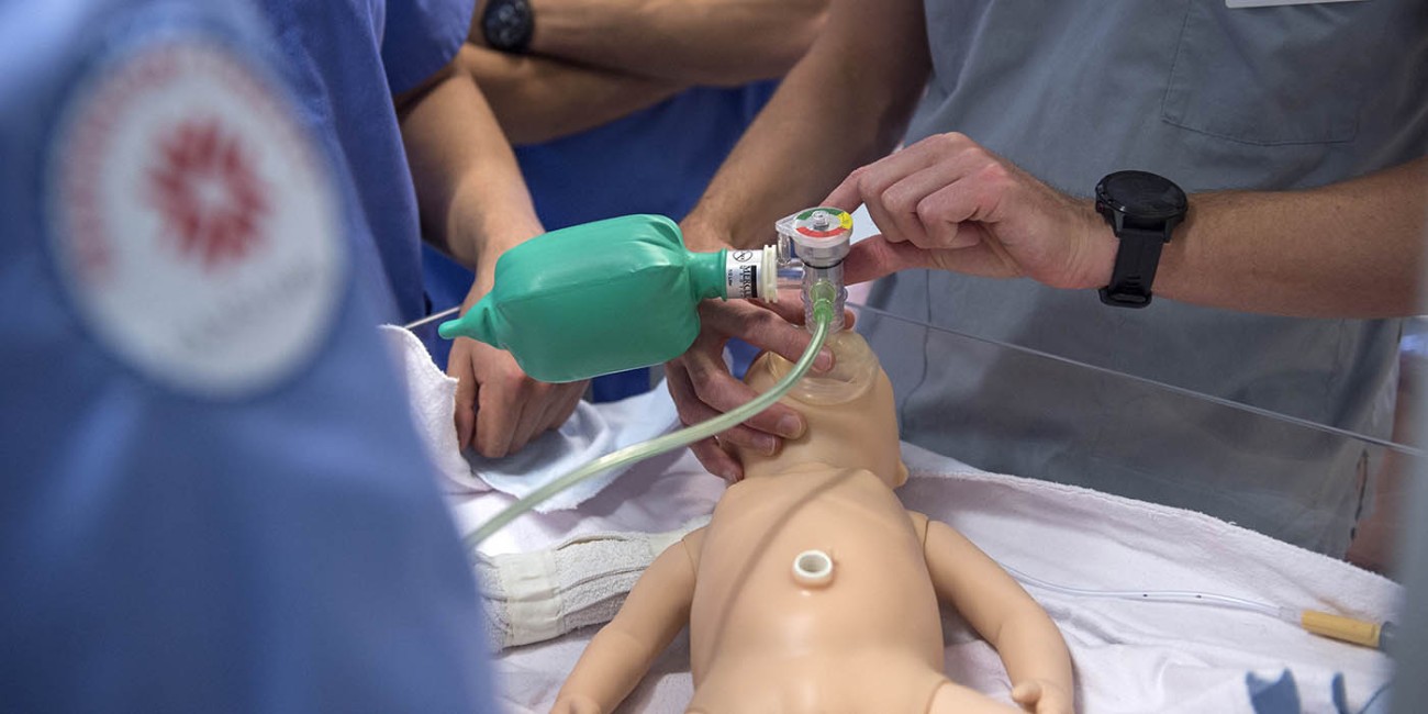 At the School of Health Sciences of Fanshawe College at the London Campus, a medical professional is using a bag valve mask to provide ventilation to a baby mannequin.