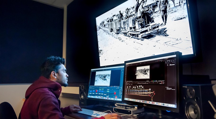 Student working on adding in visual effects to video in lab