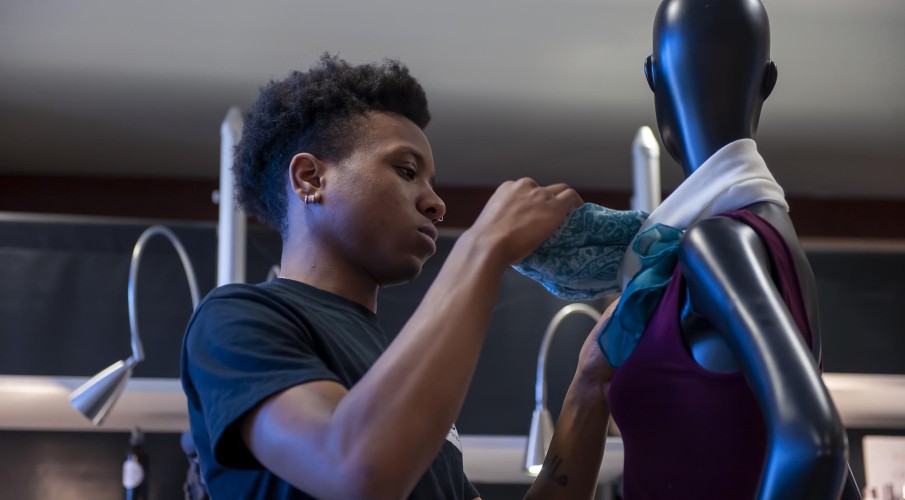 Fashion Marketing and Management student, setting up merchandise in Live Chic store