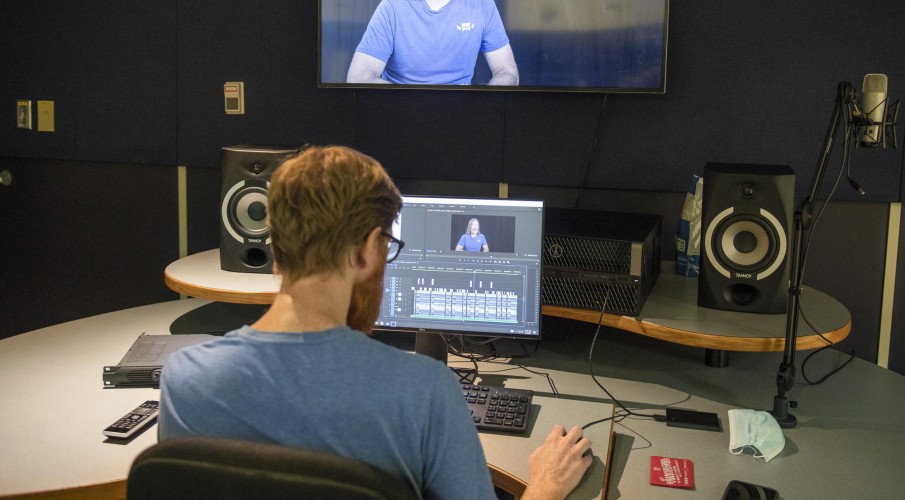 Broadcasting - Television and Film Production student editing video in studio