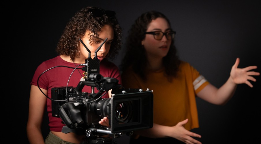 Film students look at a shot through a camera