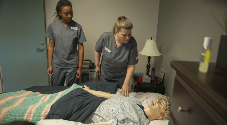 Dummy patient surrounded by Fanshawe nursing students