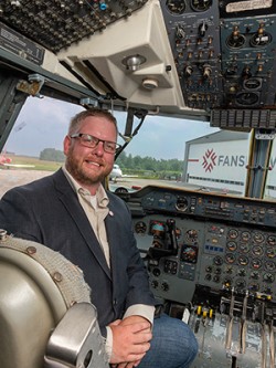 Portrait of Tim Anderson inside a plane cockpit