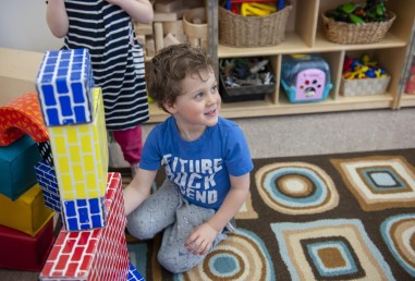 Young child playing with blocks in daycare setting