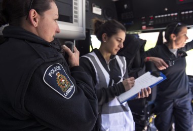 Three police officers, organizing and communicating during a crisis