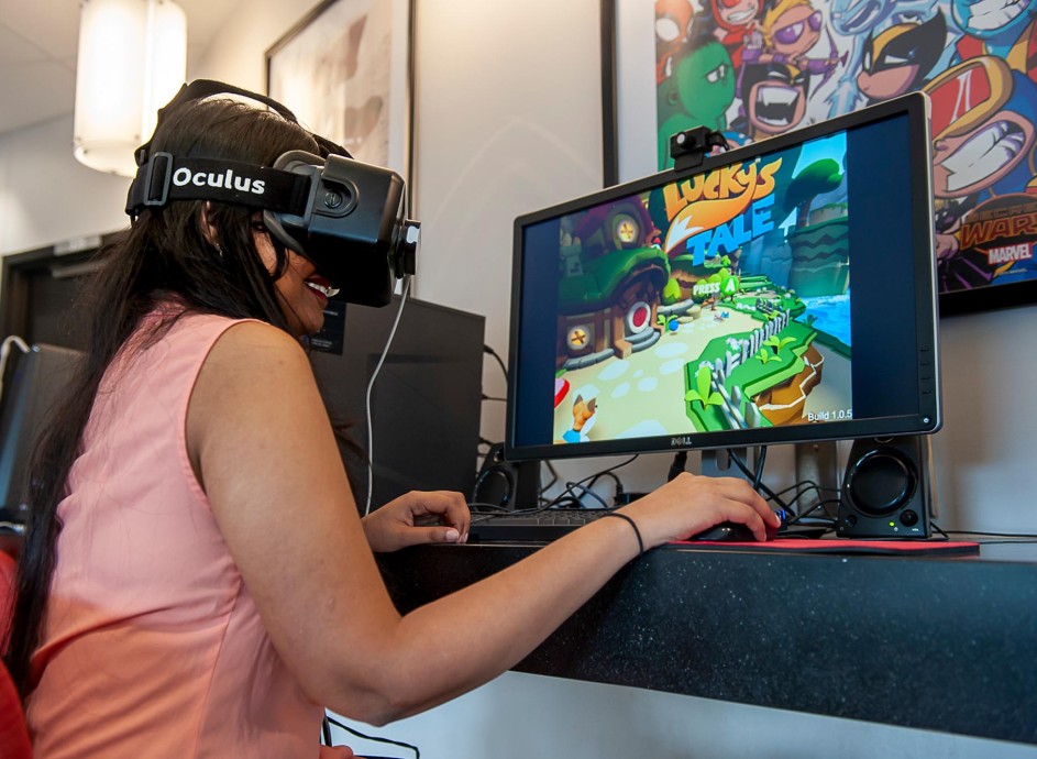 Student with VR goggles and video game on screen