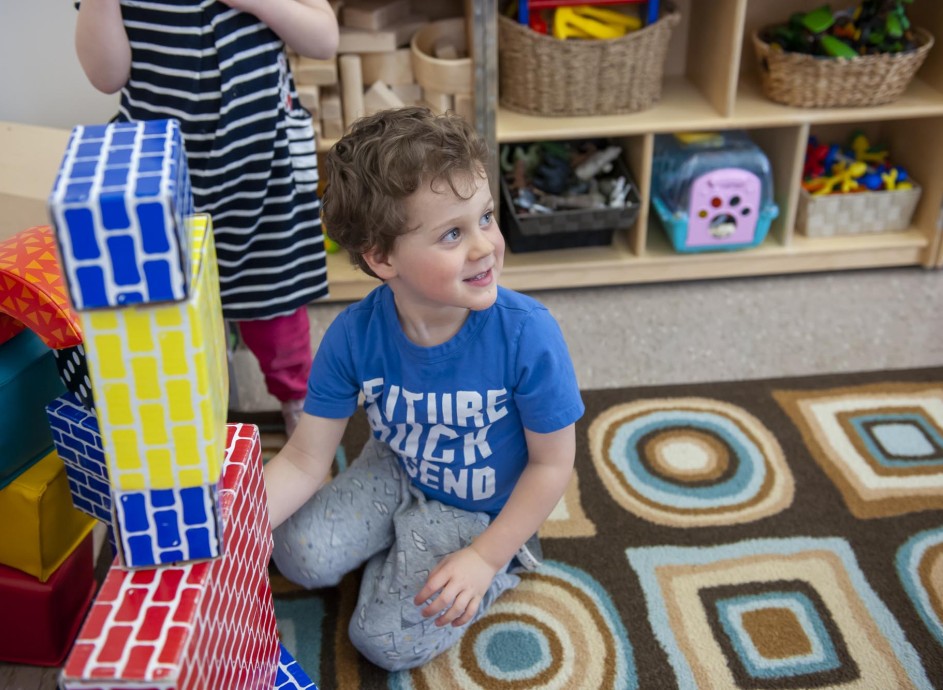 Young child playing with blocks in daycare setting