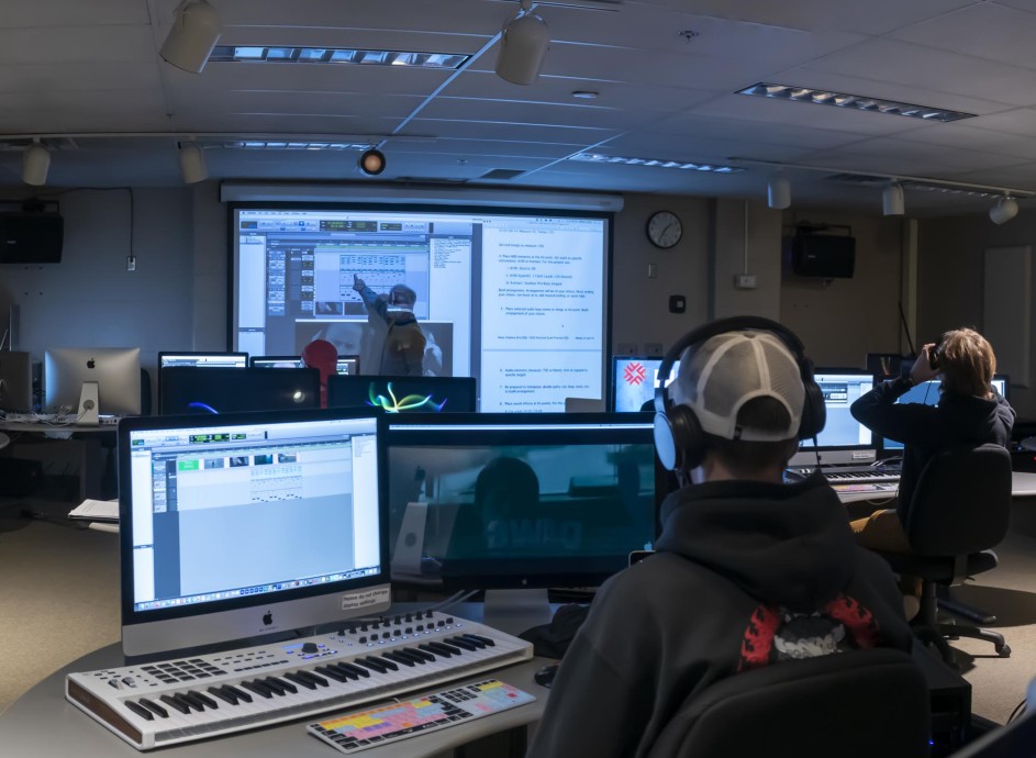 Students in class with professor at white board in audio post-production computer at Fanshawe Collegelab