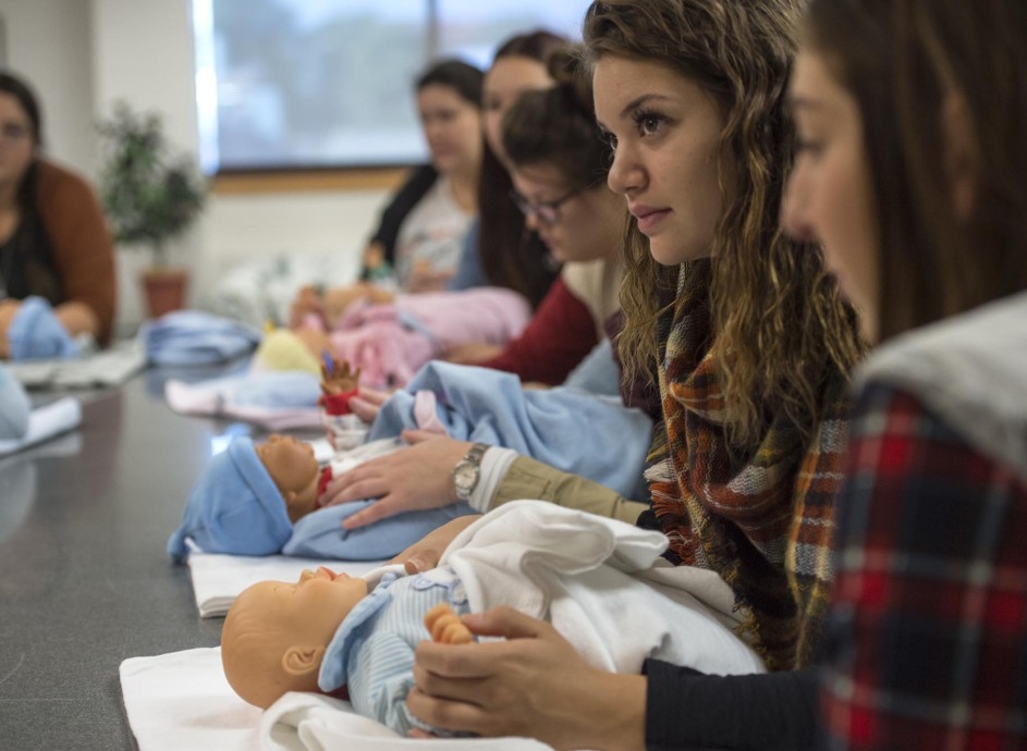 Students in doula class, paying attention to instructor
