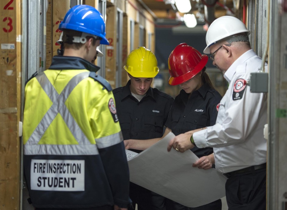 Instructor guiding students through fire inspection process