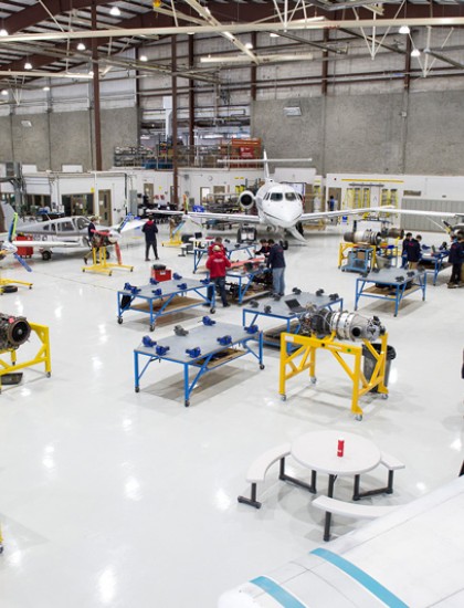 Overhead shot of students working in the hangar at the Norton Wolf School of Aviation Technology