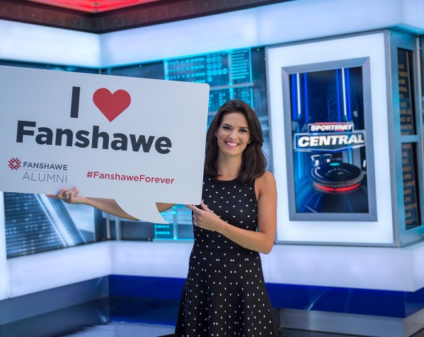 Caroline Cameron holding up the Fanshawe logo