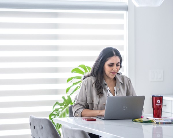 Student sitting in their home working on their laptop