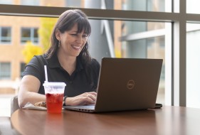 Photo of a student working on their laptop
