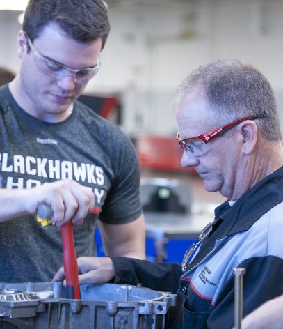 Instructor assisting student in Automotive Service Technician lab